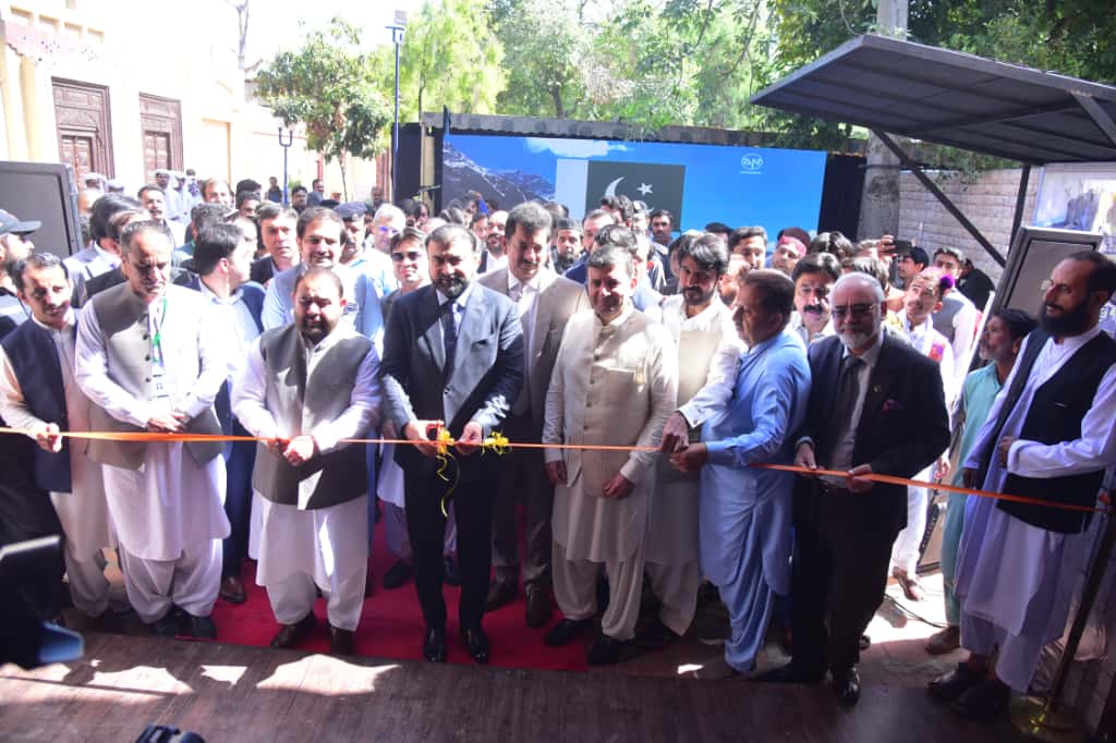"Chief Minister Mir Sarfraz Bugti inaugurating the Balochistan Grand Tourism Festival at Lok Virsa, surrounded by Balochi artists, musicians, and visitors."