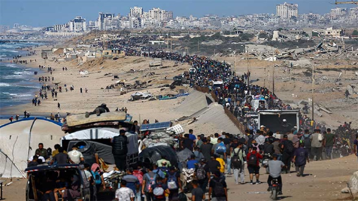 “Displaced Palestinians walk through the rubble of Gaza City as a ceasefire between Hamas and Israel takes effect.” (Alternative if the image shows aid delivery) “Humanitarian aid trucks enter Gaza following the Israel-Hamas ceasefire amid warnings of famine and malnutrition.”